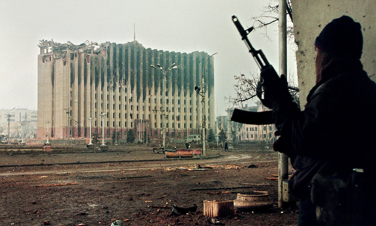 A Chechen fighter taking cover from sniper fire in Grozny, 1995.